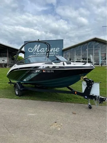 Slide: The Image of 2021 Yamaha AR195 boat with people relaxing on a lake. - 2