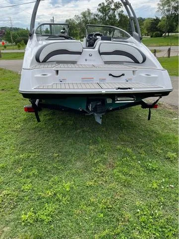 Slide: The Image of Three people enjoying a ride on a 2021 Yamaha AR195 boat. - 3