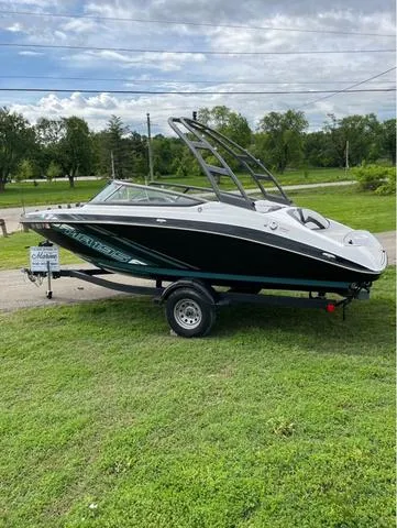 Slide: The Image of 2021 Yamaha AR195 boat speeding on water with passengers enjoying the ride. - 4