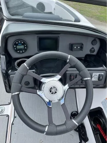 Slide: The Image of 2021 Yamaha AR195 boat with people enjoying water activities on a lake. - 8