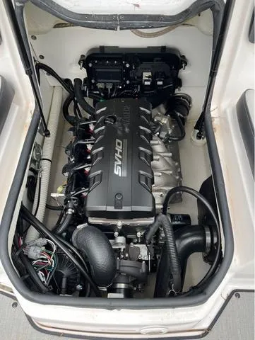 Slide: The Image of 2021 Yamaha Boats AR195, sleek black and teal design, side view. - 9