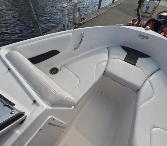 Slide: The Image of 2016 Chaparral 19 H2O Sport boat interior with white seating and cup holder. - 10