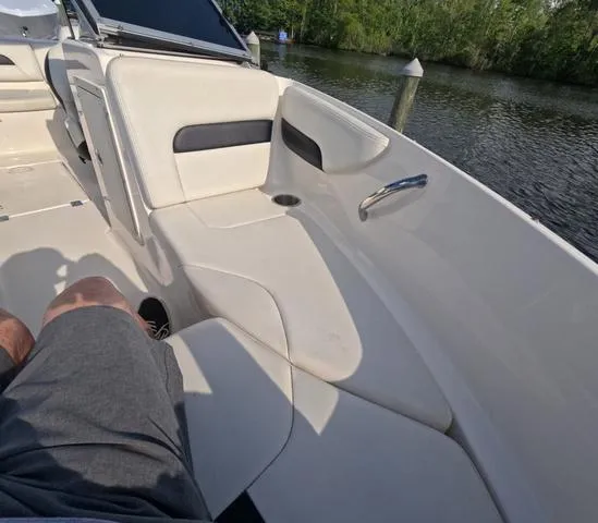 Slide: The Image of 2016 Chaparral 19 H2O Sport boat interior with white seating by the water. - 11