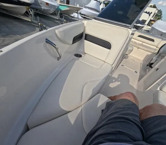 Slide: The Image of 2016 Chaparral 19 H2O Sport boat interior with white seating and cup holder. - 12