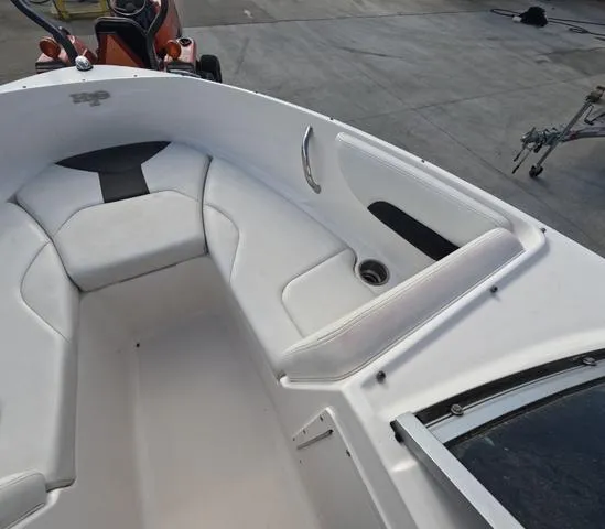 Slide: The Image of 2016 Chaparral 19 H2O Sport boat interior with white seating and cup holder. - 9