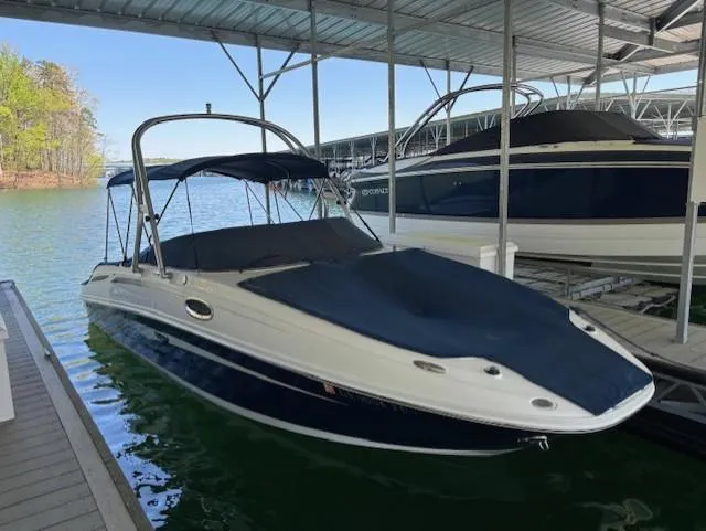 Slide: The Image of 2010 Sea Ray 260 Sundeck boat docked under a covered marina. - 0
