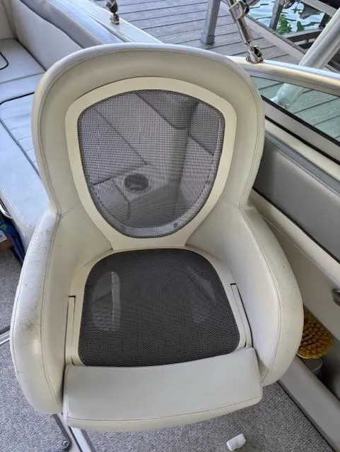Slide: The Image of 2010 Sea Ray 260 Sundeck boat seat with mesh backrest and white upholstery. - 10