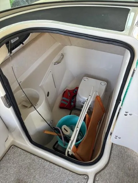 Slide: The Image of 2010 Sea Ray 260 Sundeck interior storage with marine toilet and accessories. - 11