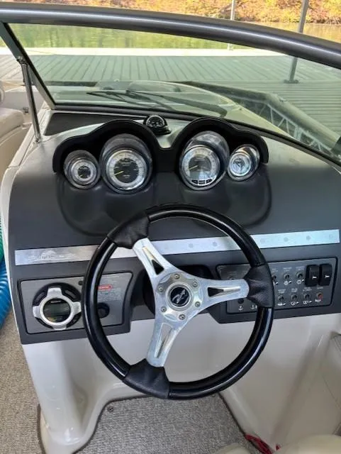 Slide: The Image of 2010 Sea Ray 260 Sundeck dashboard with steering wheel and instrument panel. - 13
