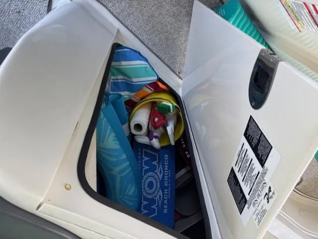 Slide: The Image of Storage compartment on a 2010 Sea Ray 260 Sundeck with beach gear and accessories. - 14