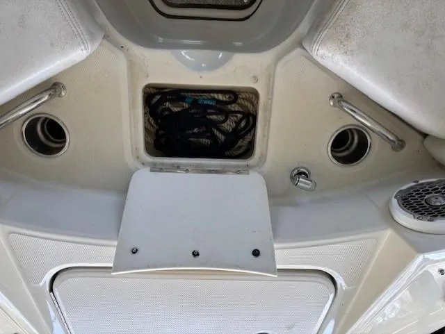 Slide: The Image of 2010 Sea Ray 260 Sundeck interior with storage compartment and seating area. - 18