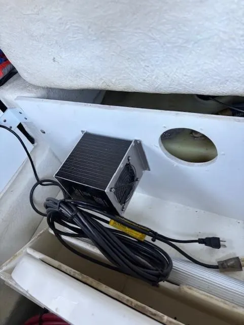 Slide: The Image of 2010 Sea Ray 260 Sundeck interior with electronic equipment and wiring. - 23