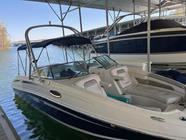 Slide: The Image of 2010 Sea Ray 260 Sundeck boat docked in a marina, featuring a sleek design and spacious seating. - 3