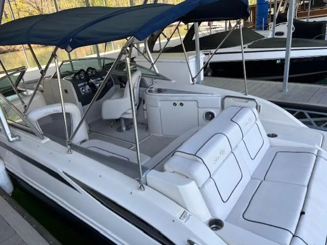 Slide: The Image of 2010 Sea Ray 260 Sundeck with blue canopy, docked at marina. - 4