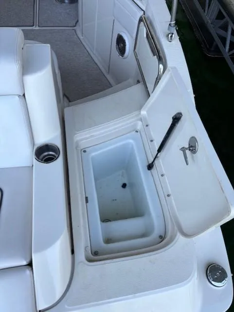 Slide: The Image of 2010 Sea Ray 260 Sundeck boat with open storage compartment and seating area. - 5