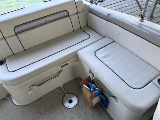 Slide: The Image of Interior seating of a 2010 Sea Ray 260 Sundeck boat, featuring white cushioned seats. - 9
