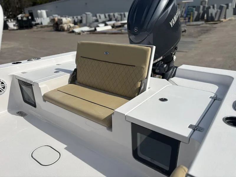 Slide: The Image of 2025 Sportsman Masters 227 boat with beige seating and Yamaha engine, docked outdoors. - 10