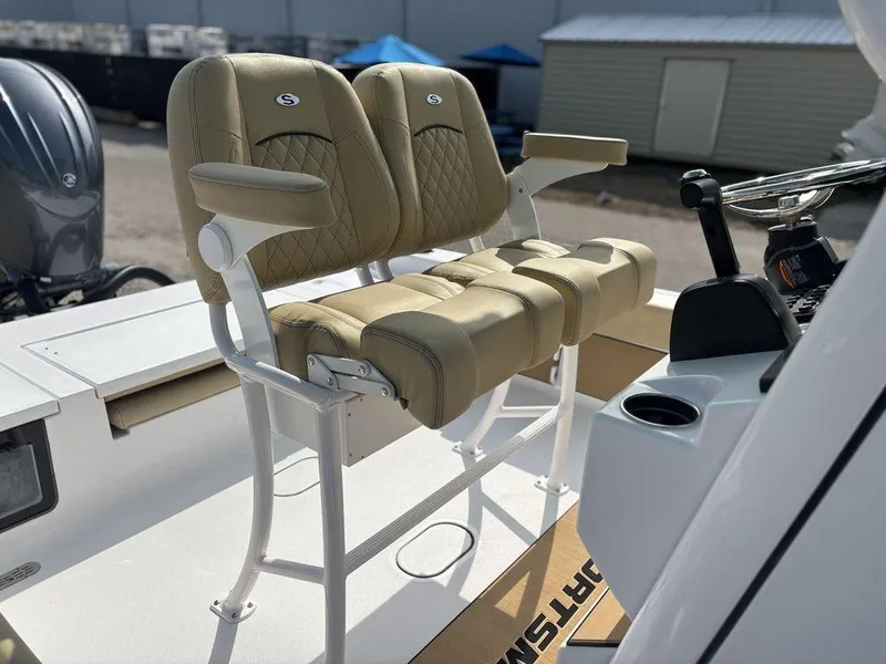 Slide: The Image of 2025 Sportsman Masters 227 boat seats, beige upholstery, dual seating with armrests, outdoor setting. - 11