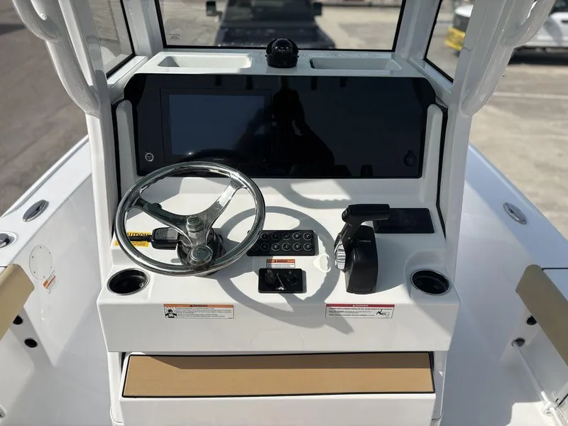 Slide: The Image of 2025 Sportsman Masters 227 boat console with steering wheel and control panel. - 12