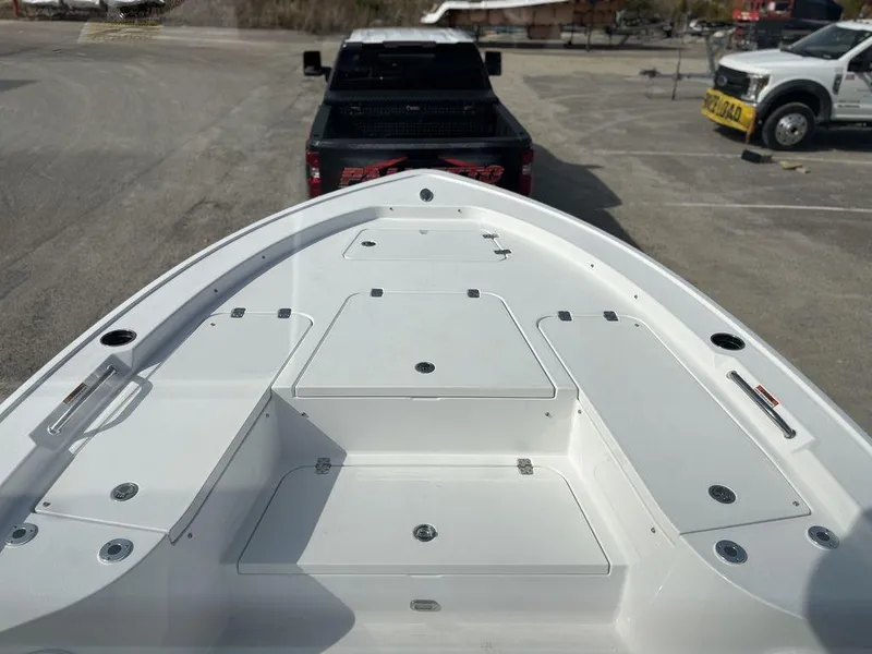 Slide: The Image of 2025 Sportsman Masters 227 boat bow view, parked near trucks in a lot. - 14