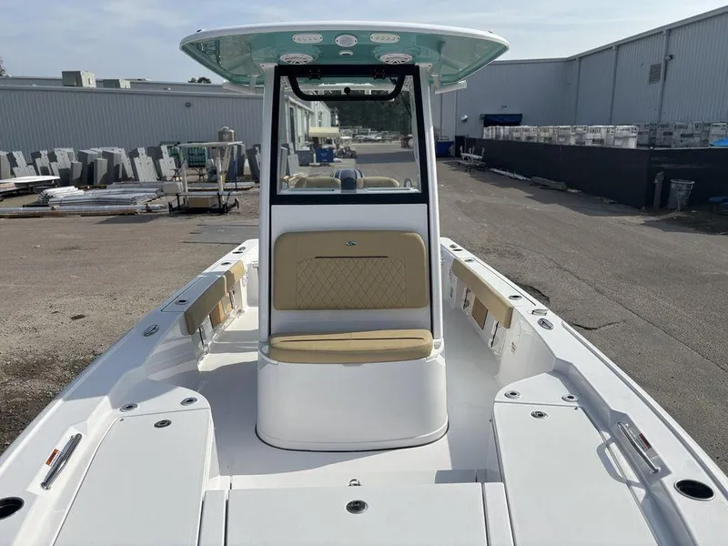 Slide: The Image of 2025 Sportsman Masters 227 boat, white exterior, spacious deck, modern design, docked outdoors. - 15