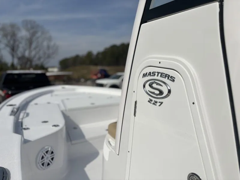 Slide: The Image of 2025 Sportsman Masters 227 boat, white exterior, close-up view, outdoors. - 16