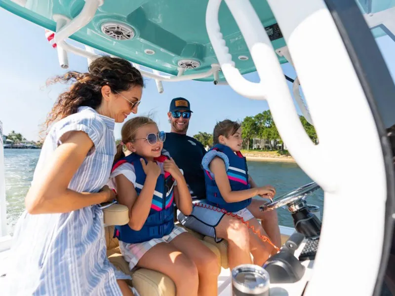 Slide: The Image of Family enjoying a ride on a 2025 Sportsman Masters 227 boat. - 20