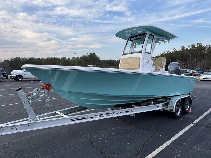 Slide: The Image of 2025 Sportsman Masters 227 boat on trailer in parking lot, under cloudy sky. - 8