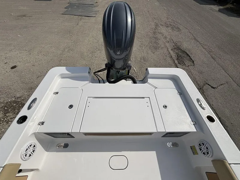 Slide: The Image of 2025 Sportsman Masters 227 boat stern view with outboard motor and storage compartments. - 9