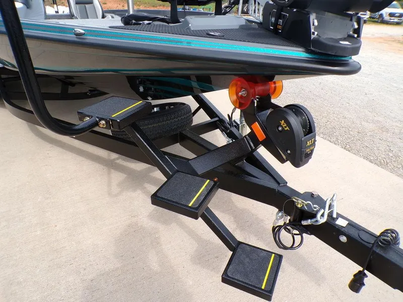 Slide: The Image of 2025 Phoenix 721 ZXL boat trailer with steps and winch on concrete surface. - 13