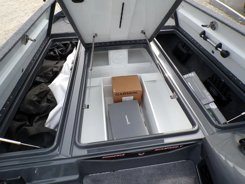 Slide: The Image of 2025 Phoenix 721 ZXL boat storage compartment with Garmin equipment boxes inside. - 20