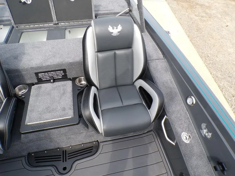 Slide: The Image of 2025 Phoenix 721 ZXL boat interior with black and gray seating and cup holders. - 21