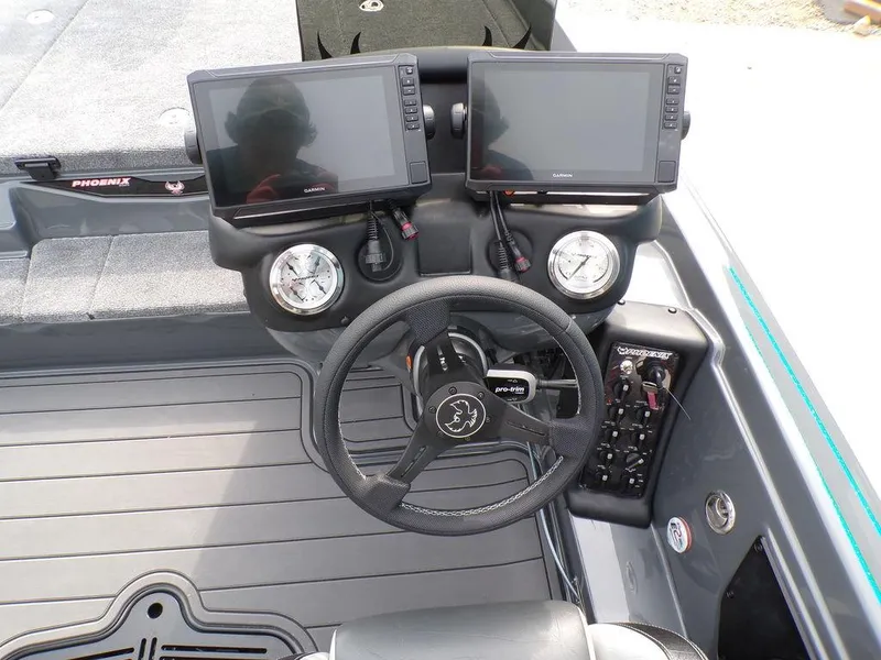 Slide: The Image of 2025 Phoenix 721 ZXL boat dashboard with dual Garmin displays and steering wheel. - 5