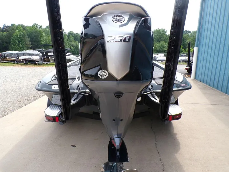 Slide: The Image of 2025 Phoenix 721 ZXL boat with powerful 250 engine, parked outdoors. - 9