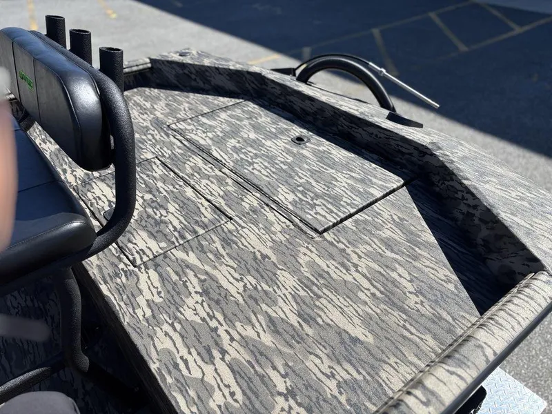 Slide: The Image of Camouflage-patterned deck of a 2025 Havoc 1965 UCC boat with seating and storage. - 11