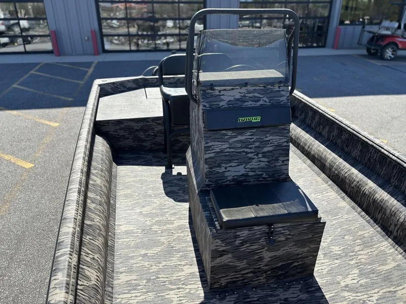 Slide: The Image of 2025 Havoc 1965 UCC boat with camouflage design, parked outdoors. - 15