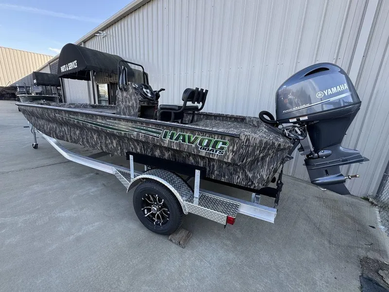 Slide: The Image of 2025 Havoc 1965 UCC boat with Yamaha motor on trailer, parked outdoors. - 5