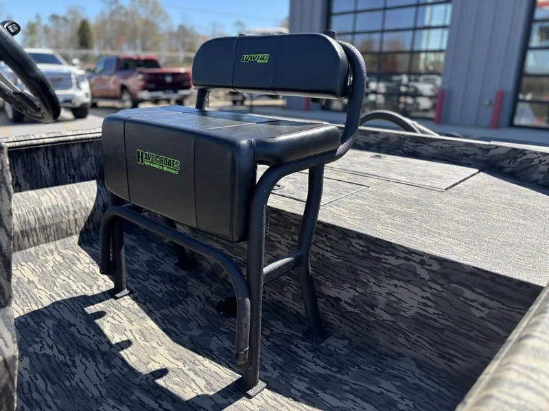 Slide: The Image of 2025 Havoc 1965 UCC boat seat, black upholstery, outdoor setting, modern design. - 9