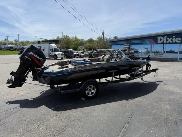 Slide: The Image of 2000 Ranger R97 boat with Mercury outboard motor parked outside dealership. - 6