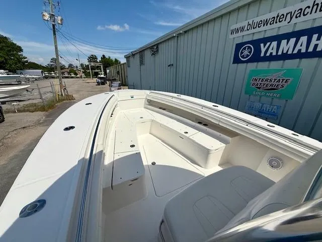 Slide: The Image of 2017 Regulator 31 boat with spacious seating, docked near Yamaha dealership. - 11