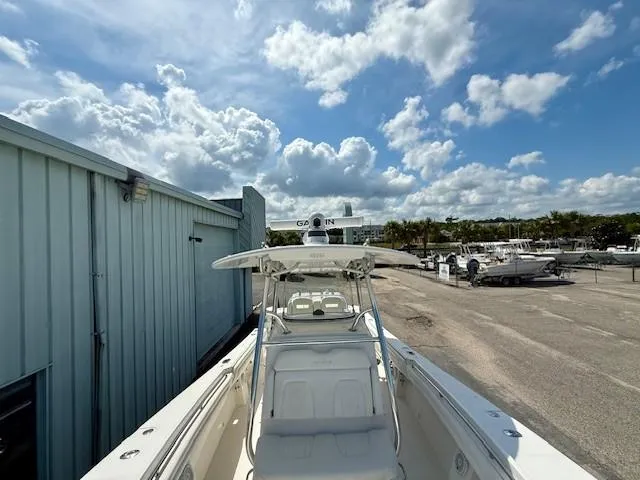 Slide: The Image of 2017 Regulator 31 boat docked under a partly cloudy sky. - 12