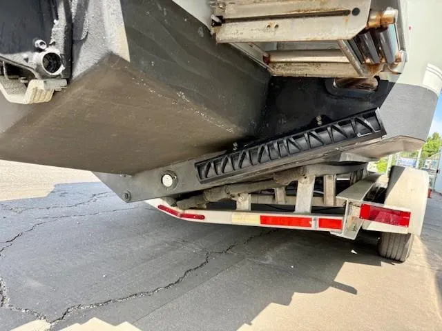 Slide: The Image of 2017 Regulator 31 boat on trailer, showing hull and trailer details. - 5