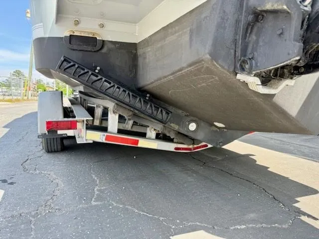 Slide: The Image of 2017 Regulator 31 boat on trailer, showing hull and trailer details. - 6