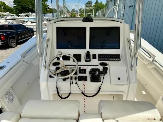 Slide: The Image of 2017 Regulator 31 boat dashboard with dual screens and steering wheel. - 7