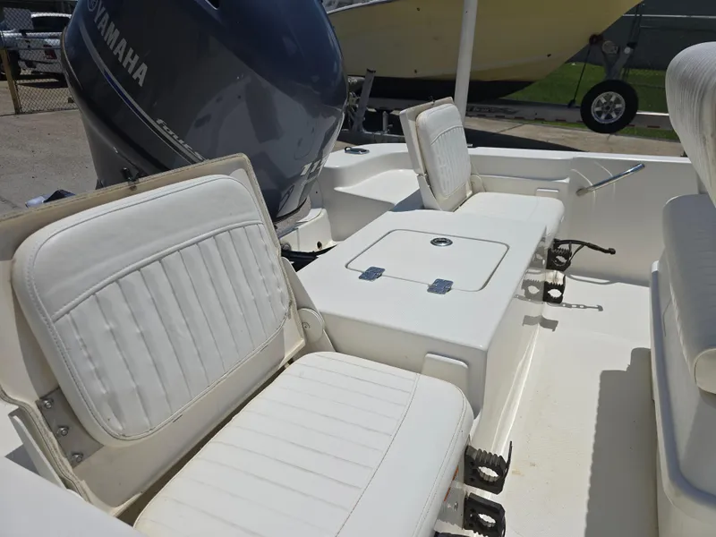 Slide: The Image of 2010 NauticStar 1810 Nautic Bay boat interior with white seating and Yamaha engine. - 10