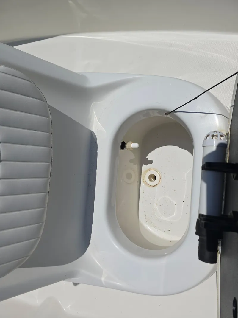 Slide: The Image of 2010 NauticStar 1810 Nautic Bay boat interior with seating and storage compartment. - 12