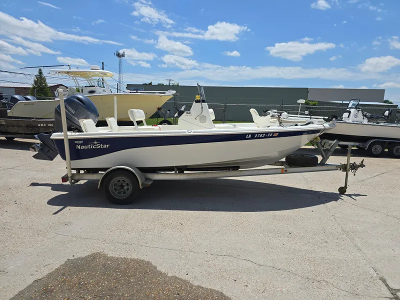 Slide: The Image of 2010 NauticStar 1810 Nautic Bay boat on trailer under clear sky. - 6