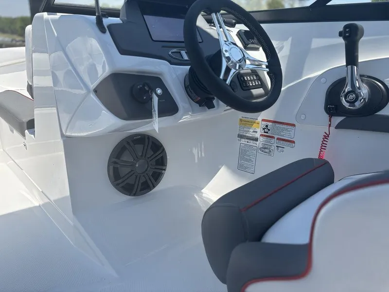 Slide: The Image of 2024 Tahoe 210 S boat cockpit with steering wheel and control panel. - 13