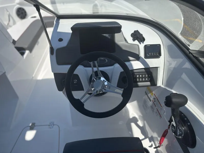 Slide: The Image of 2024 Tahoe 210 S boat dashboard with steering wheel and control panel. - 14