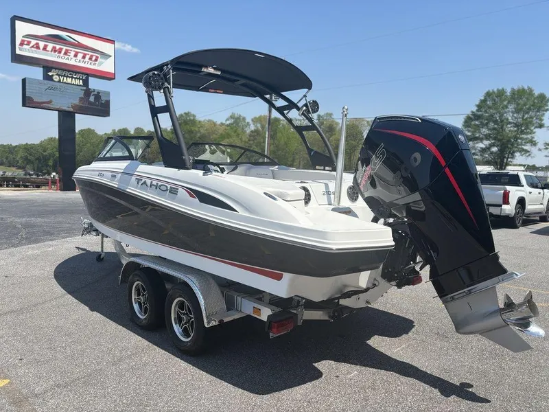Slide: The Image of 2024 Tahoe 210 S boat on trailer at dealership, featuring sleek design and powerful outboard motor. - 3